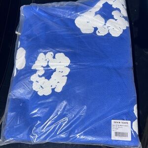 Denim Tears Blue Hoodie with White Floral Design
